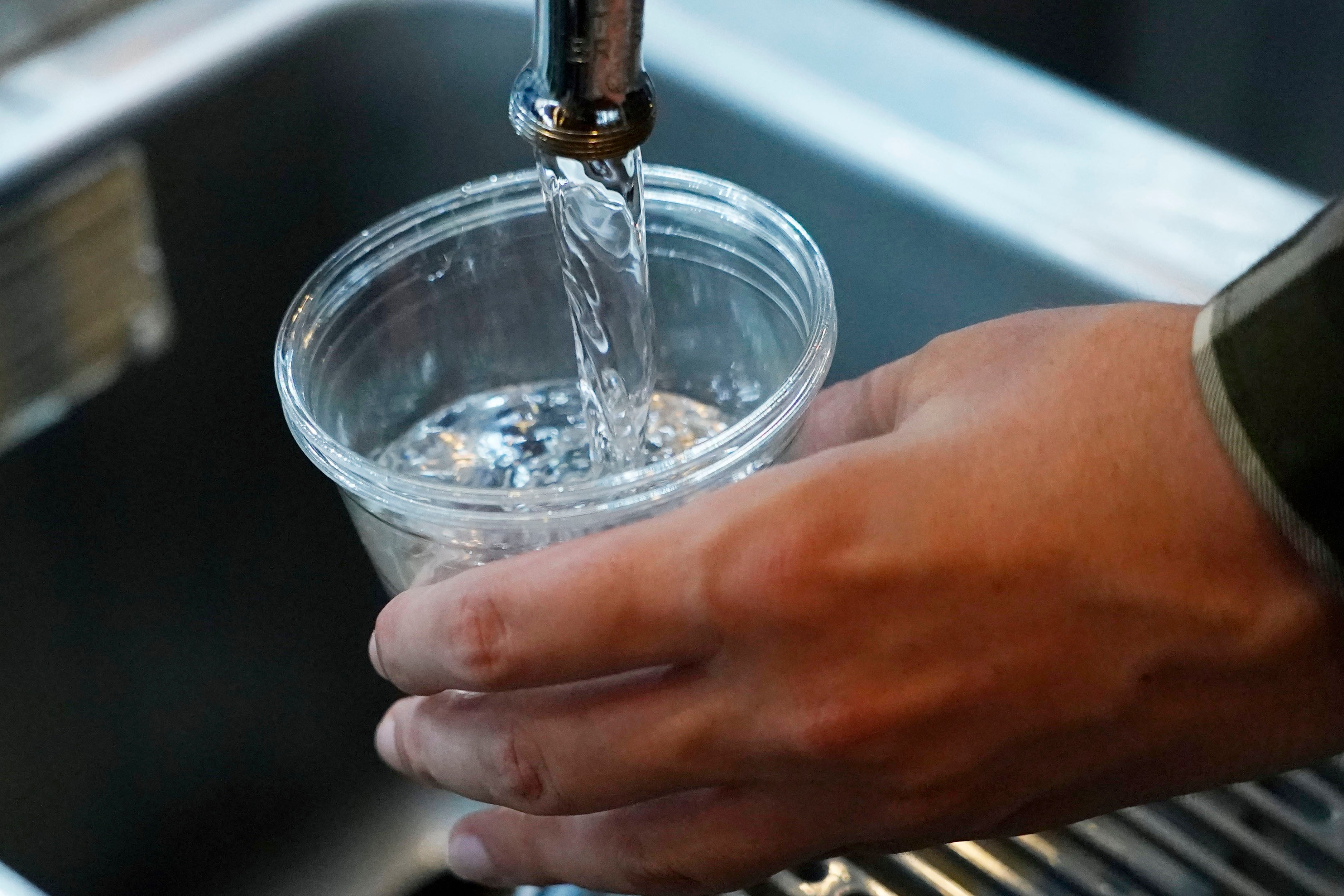 A cup of water is pulled from the faucet at Johnny T's Bistro and Blues in Jackson, Mississippi, in September 2022. The southern state requires all public water systems that serve at least 2,000 people to be activated. fluoridation, according to the Fluoride Action Network.