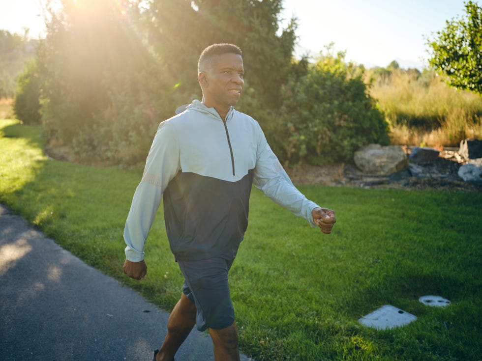 an elderly man exercising in the park in the morning